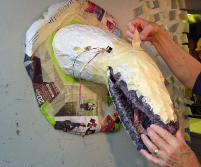 taping on the paper mache jaws